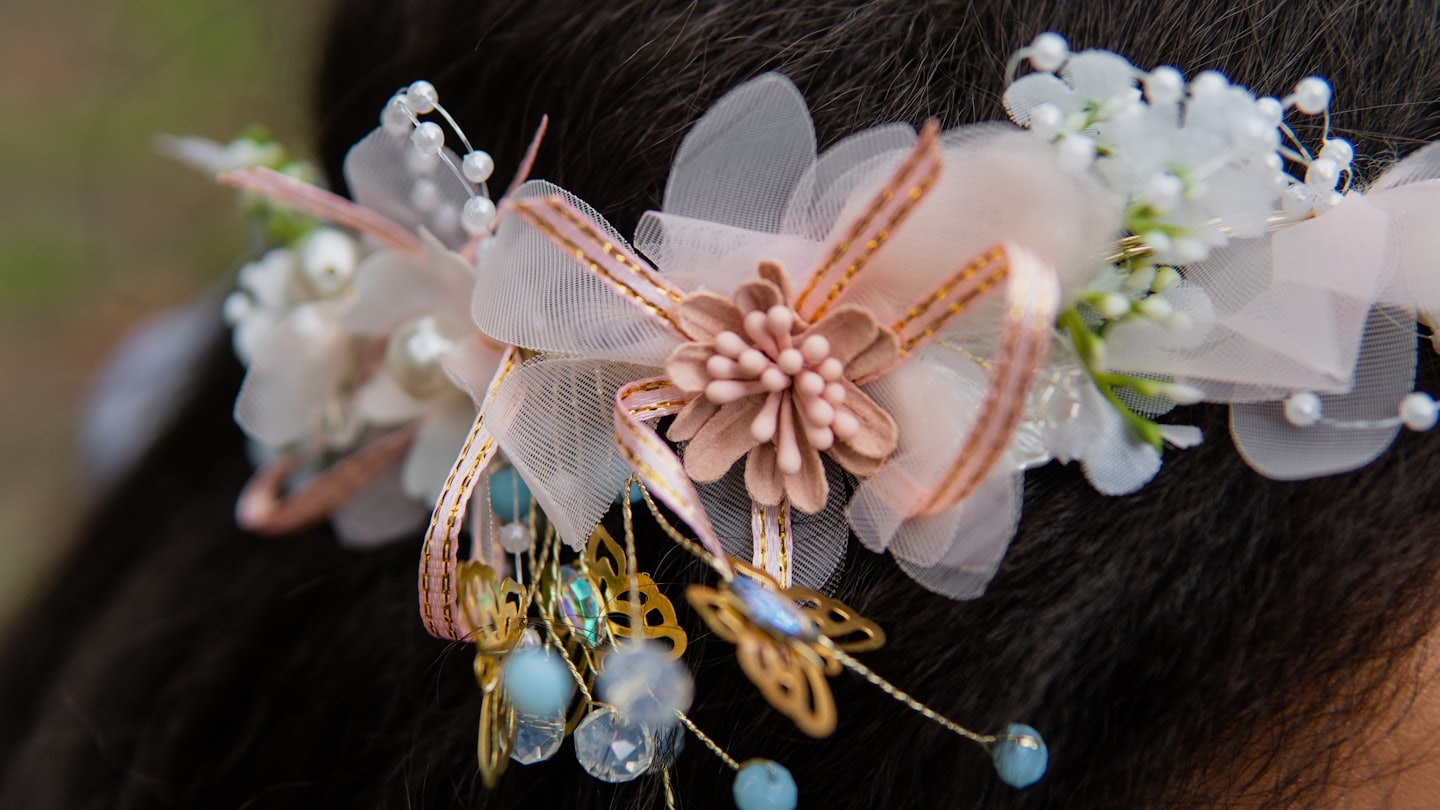 Intricate floral and butterfly hair accessory worn in dark hair.